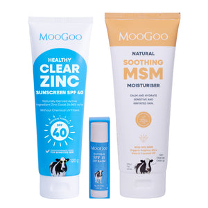 Three MooGoo skincare products arranged on a white background: a large blue tube of Healthy Clear Zinc sunscreen SPF 40, a smaller blue tube of Natural SPF 15 Lip Balm, and a large white-and-gold tube of Natural Soothing MSM Moisturiser. MooGoo Summer essentials pack for after sun care. 