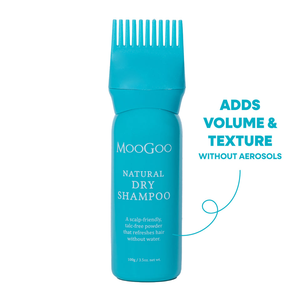 A turquoise blue bottle of MooGoo Natural Dry Shampoo with a matching wide-tooth comb applicator on top, shown on a white background. Adds volume and texture without aerosols. 