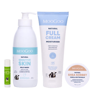 MooGoo Dry Skin Rescue Pack featuring a light blue Natural full cream moisturiser tube, a sensitive skin milk wash pump bottle, a small shea sorbet vanilla butter balm jar, and a cow illustration on the labels, all on a white background. For skin repair and barrier protection.