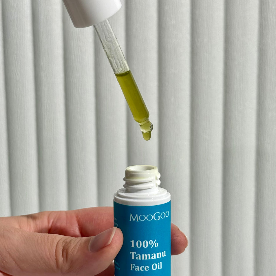 A vial containing MooGoo 100% Tamanu face oil being dripped into the bottle. 