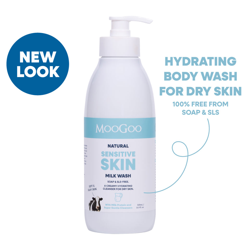 A bottle of MooGoo Natural Sensitive Skin Milk Wash with a pump dispenser, shown on a white background with promotional text and a blue 'NEW LOOK' badge. Hydrating face and body wash with phthalate free fragrance for dry and sensitive skin. Free From Soap and SLS. 