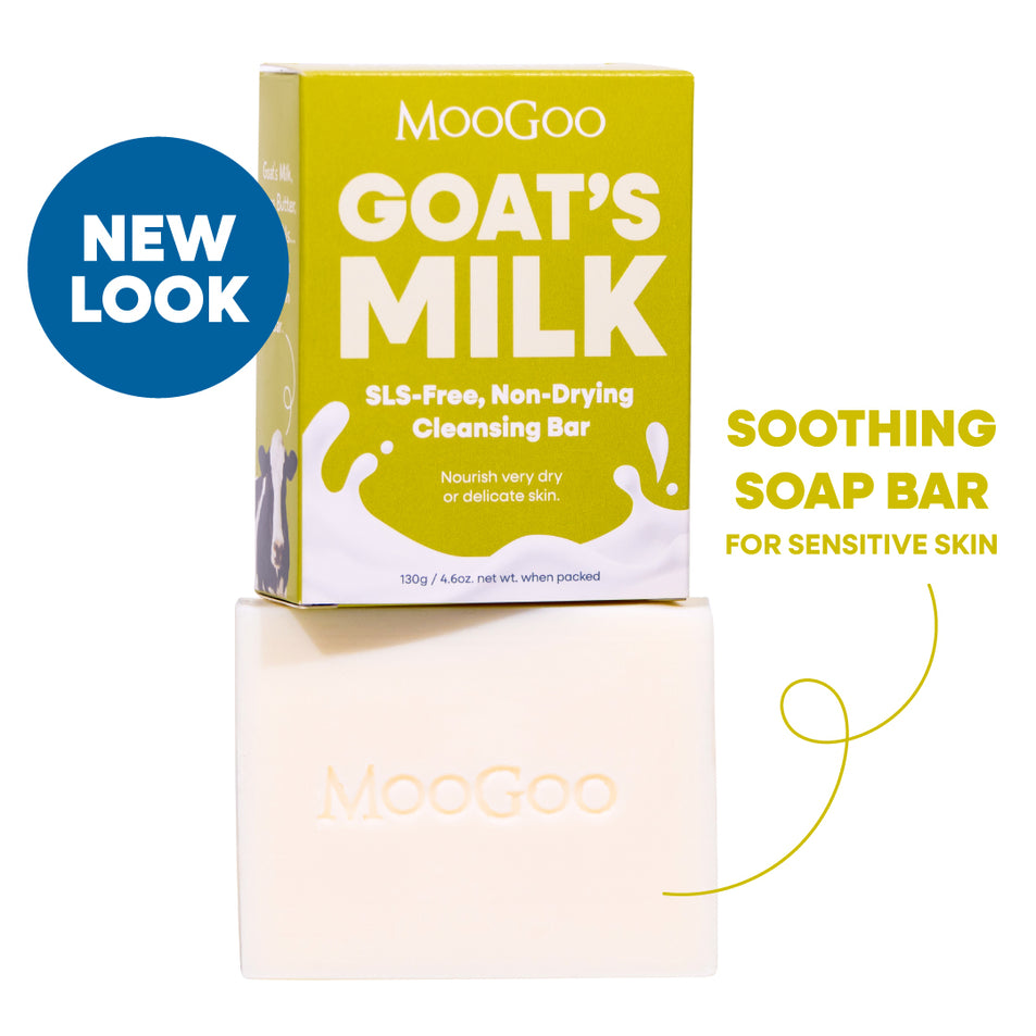 MooGoo Goat's Milk Soothing Cleansing Bar shown with its yellow-green packaging box and the bar itself on a white background. SLS free soothing soap bar for sensitive skin to calm and hydrate delicate or irritated skin.